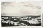 Utsikt över slingrande älv och fjäll på längre avstånd.