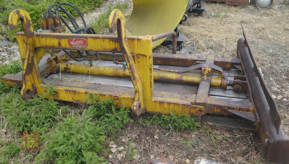 Feste for bruk på hjullaster. Gul og svart. Hydraulisk drevet.