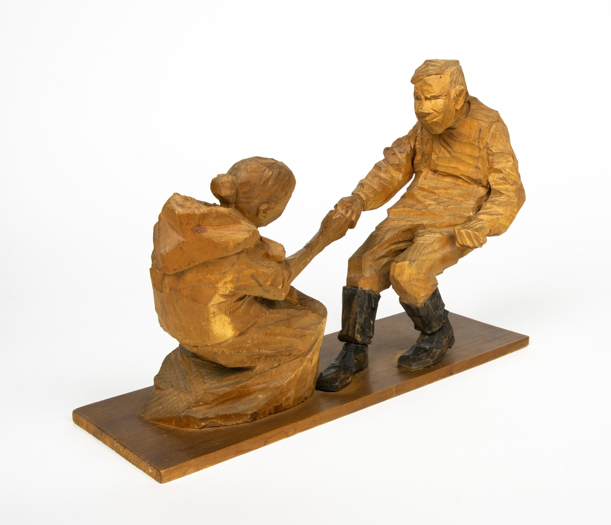 Skulptur i trä av Döderhultarn. Skulpturen föreställer två figurer, en man och en hustru i en dragkamp, så kallad ”fingerkrok”. På figurens fotplatta finns en dedikation: ”Från Axel Petersson till Flygaren å vännen Rodéhn 2/9 1919. En ringa gärd af tacksamhet för tvänne i allo förstklassiga ”himmelsfärder”. Länge lefve Br Rodéhn!!! D.S".
Jämte dedikationen finns konstnärens signatur synlig i form av en stämpel.