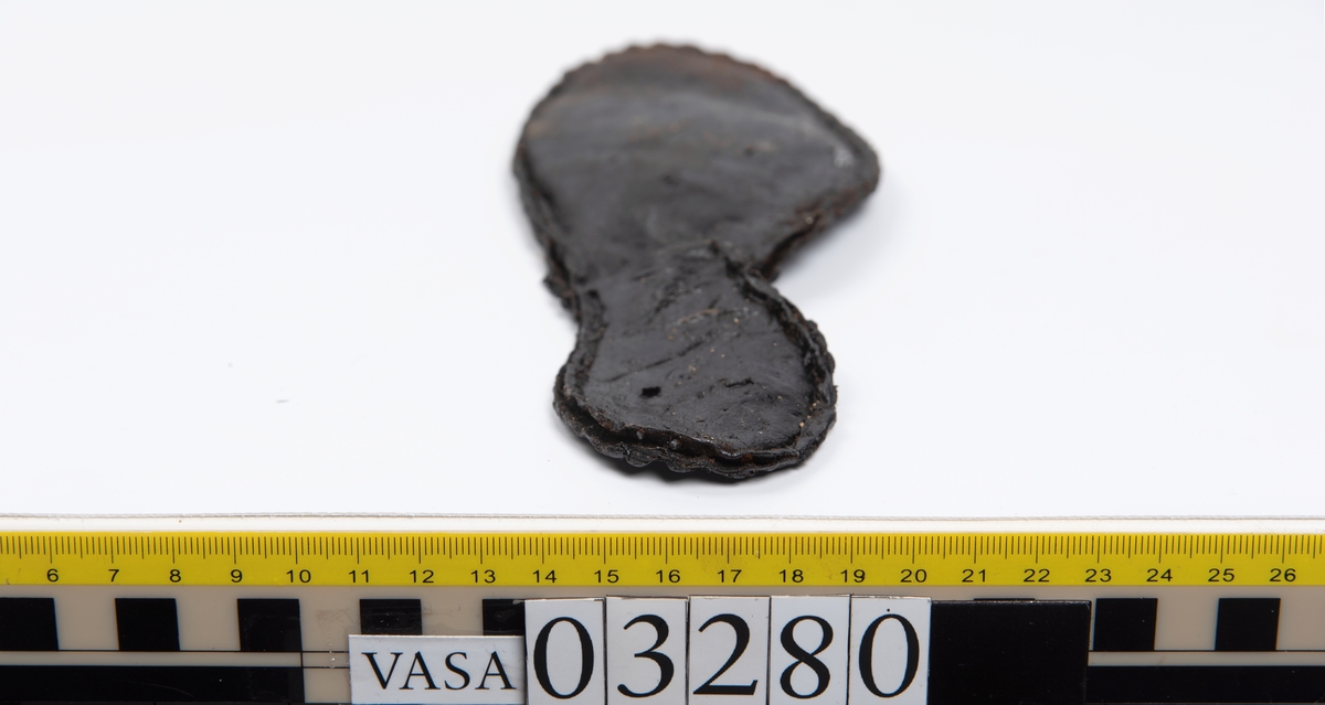 Tjugofem delar och fragment från stövel.
En sula, fyndnummer 03280. På sulans ovansida syns intryck av bindtråd. Runt ytterkanterna löper stygnshål. I hälpartiet finns hål efter träpligg.
Del av en klack, fyndnummer 03280:1, i form av fyra klacklappar samt kvarsittande träpligg.
En stropp, fyndnummer 03280:2. Ena änden är spetsformad. Andra änden är något fragmentarisk. I bägge ändar finns hål efter stygn.
Tre delar från stövelskaftet i form av tre läderstycken. Lädrstyckena är spaltade och ligger vikta. Längs sidorna löper stygnshål.
Delar och fragment av sulor, inlägg, ovanläder mm.
Merparten av lädret är spaltat och något kladdigt.