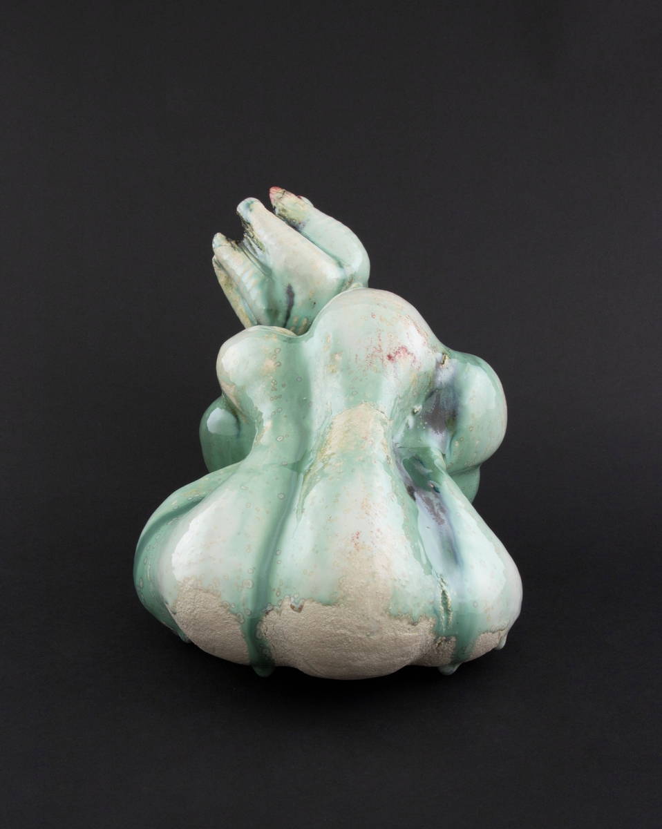 Håndmodellert skulptur i glasert steingods i nesten liggende positur. Den har en organisk og asymmetrisk kalebassform som ender i en tulipanform med halvåpne kronblader. Keramikkskulpturen inngår i en installasjon bestående av 26 deler i ulike størrelser og med individuell utforming. De asymmetriske variasjonene gir et inntrykk av bevegelse, og den lett sykelige fargepaletten gir et uhyggelig og grotesk preg. Samtlige deler minner om kjøttetende planter.