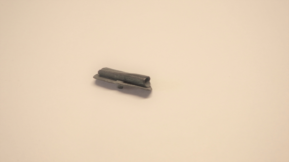 MALV: L. 18 MM, OMBØYET OG SAMMENPRESSET. UTHULT MED ISITTENDE RESTAV NAGLE. 