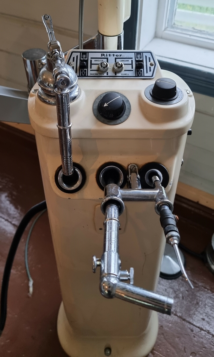 Tannlegeutstyr med bor, lampe og instrumentbrett. 