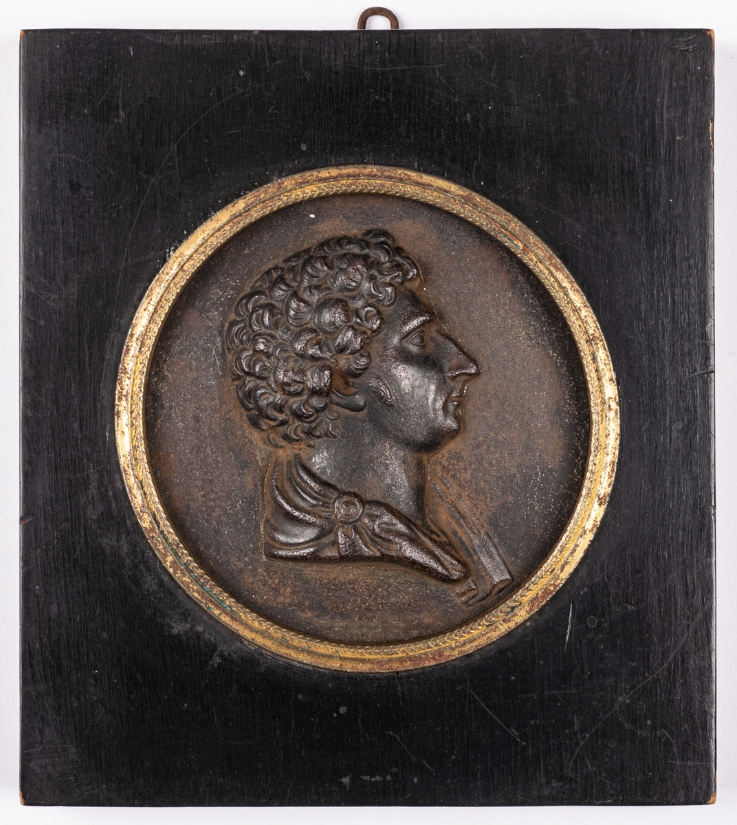 Porträttmedaljong, relief i järn, föreställande Karl XIV Johan, inom svart träram.