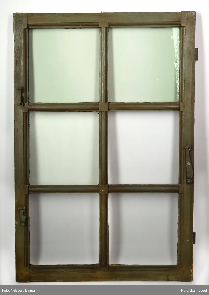 Fönster med karm, fyra fönsterbågar med vardera sex glasrutor, omkring 1740. Utvändigt målat brunt, invändigt grågrön oljefärg. 

Utåtgående fönsterbåge. Träspröjsar med en på insidan rundad vulst som möts i kvadratiskt spröjskryss. Bågens yttersida förstärkt med hörnjärn av 1700-talstyp. Fönsterkarm av furu med symmetrisk korspost. Fönsterbleck av målad plåt, fäst i karmens nederkant. Med fönsterbräda. Beslag för hängning av fönsterluckor. Gångjärn, uppställnings- och stängningsbeslag.  

Anm: Partiellt färgbortfall och skador. Ett av tre fönster, placerat på rummets långsida, mot gatan.
/Anna Arfvidsson Womack 2021-07-14