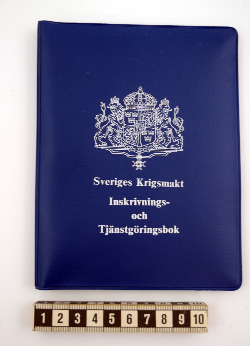 Inskrivnings- och tjänstgöringsbok av mörkblå plast med stora riksvapnet samt tryckt text i vitt: "Sveriges Krigsmakt Inskrivnings- och tjänstgöringsbok". Tre fickor av transparent plast invändigt, plats för terminslönebok och minneslista för försvarsmaktens personal samt id-bricka. I boken finns två versioner av "Minneslista" en från 1961 samt en från 1978, en terminslönebok från 1951 samt ett tjänstgöringskort från 1982.