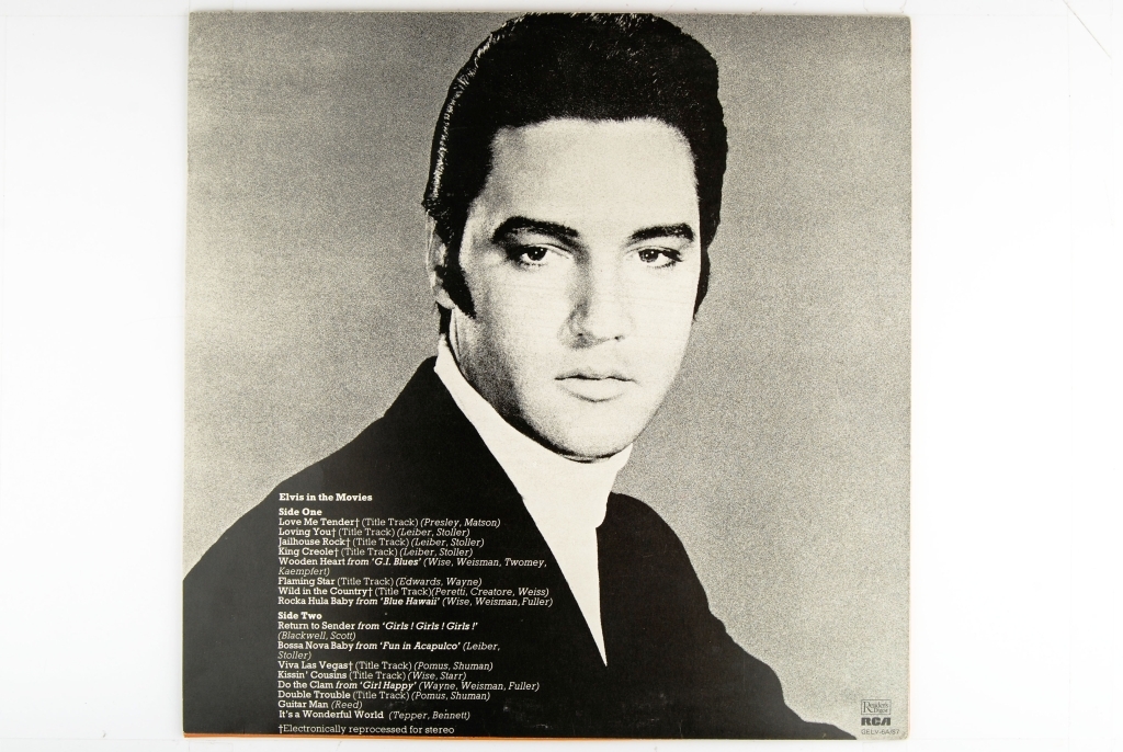 Bilde av Elvis Presley. Synger og har en gitar rundt livet.