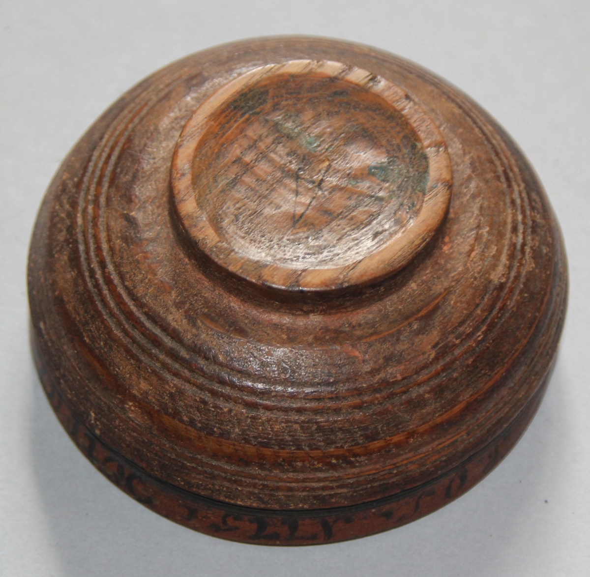 Liten dreia bolle. Rosemåla med tekst kring kanten på utsida. Teksten er utydleg men det kan lesast "R.O.S.1775 sett(?) nu mig bie(?) snart får du rusen føle" Rosemåling inni bollen, blad og blomstermotiv. Rosemålinga er noko slitt. Utanpå er bollen brunmåla, med ei grøn stripe og orange kant. Bollen har ein skade på den eine sida. denne skaden er lima.