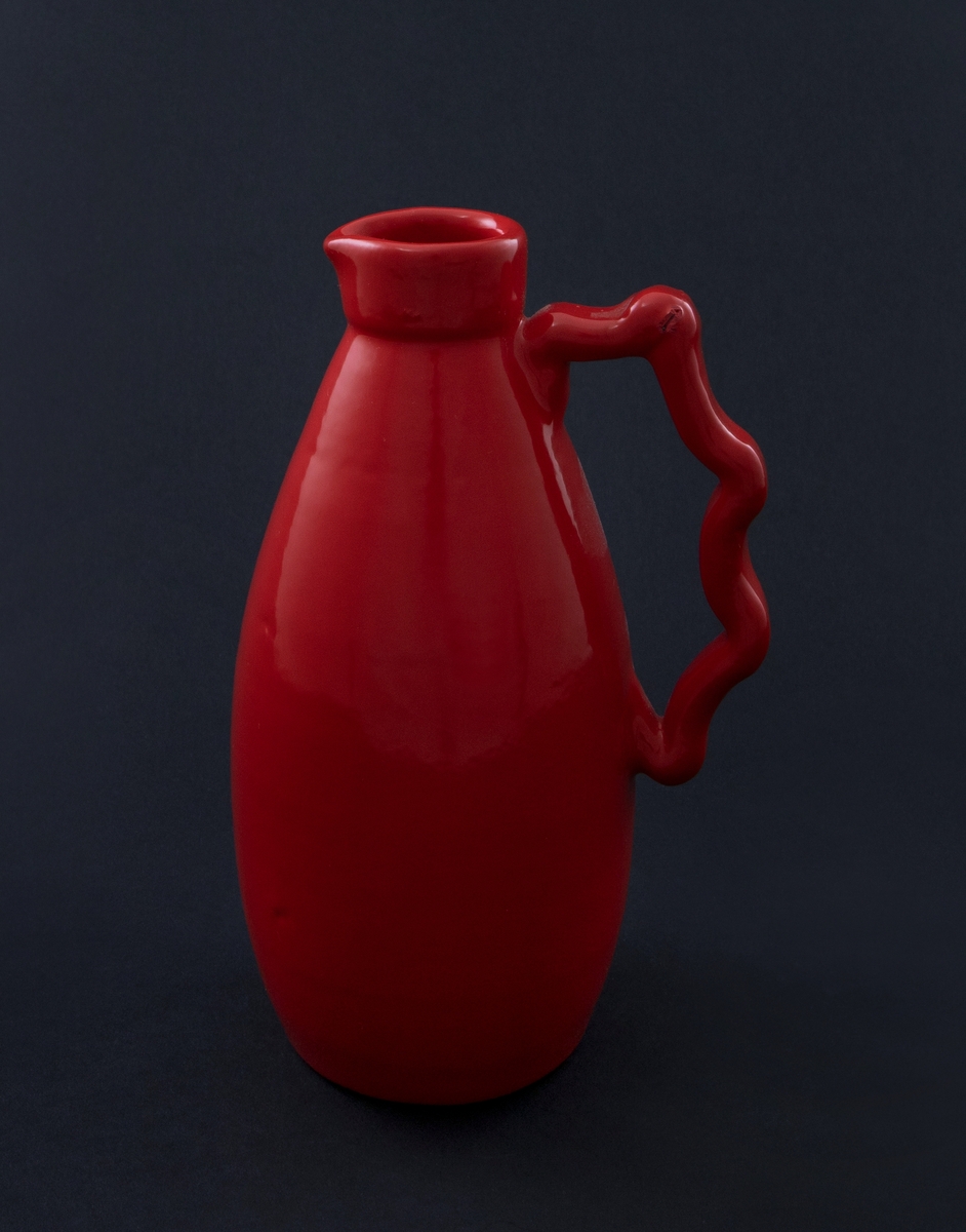 Rødlakkert keramisk vase. Slank kanneform med lav hals, tut med nebb og tvinnet lang hank.   
Vasen er en readymade, altså et funnet objekt, som kunstneren har brennlakkert. Transformasjonen gjør at kun vaseformen står igjen, mens individuell glasur, farge og eventuelt motiv er gjemt bak den nye, monokrome, blanke overflaten. I følge kunstneren er de faktiske objektene funnet i antikvitetsbutikker og loppemarkeder, og er antakelig laget i løpet av de siste 100 år.