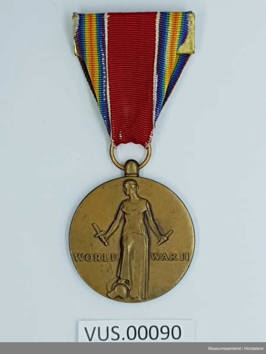 Bronsemedaljen har 3,5 cm omkrets. Forsiden er en frigjøringsfigur som står i full lengde med hodet vendt mot høyre og ser til en ny dags morgen, høyre fot hviler på en krigsguds hjelm med et knust sverd i høyre hånd og et knust blad i venstre hånden, inskripsjonen WORLD WAR II plassert rett under midten. På baksiden er inskripsjoner for de fire frihetene: FREEDOM FROM FEAR AND WANT og FREEDOM OF TALE AND RELIGION adskilt av en palmegren, alt innenfor en sirkel sammensatt av ordene UNITED STATES OF AMERICA 1941 1945. 

Medaljens opphengs- og servicebånd er 3,5 cm bredt og består av følgende striper: dobbel regnbue i sidestilling (blues, greener, gule, røde (i midten), gule greener og blues);  hvit 67101; senter 9⁄16 tommer Old Glory Red 67156;  hvit; og  dobbel regnbue ved siden av hverandre. Regnbuen på hver side av båndet er en miniatyr av mønsteret som ble brukt i seiermedaljen fra første verdenskrig. 