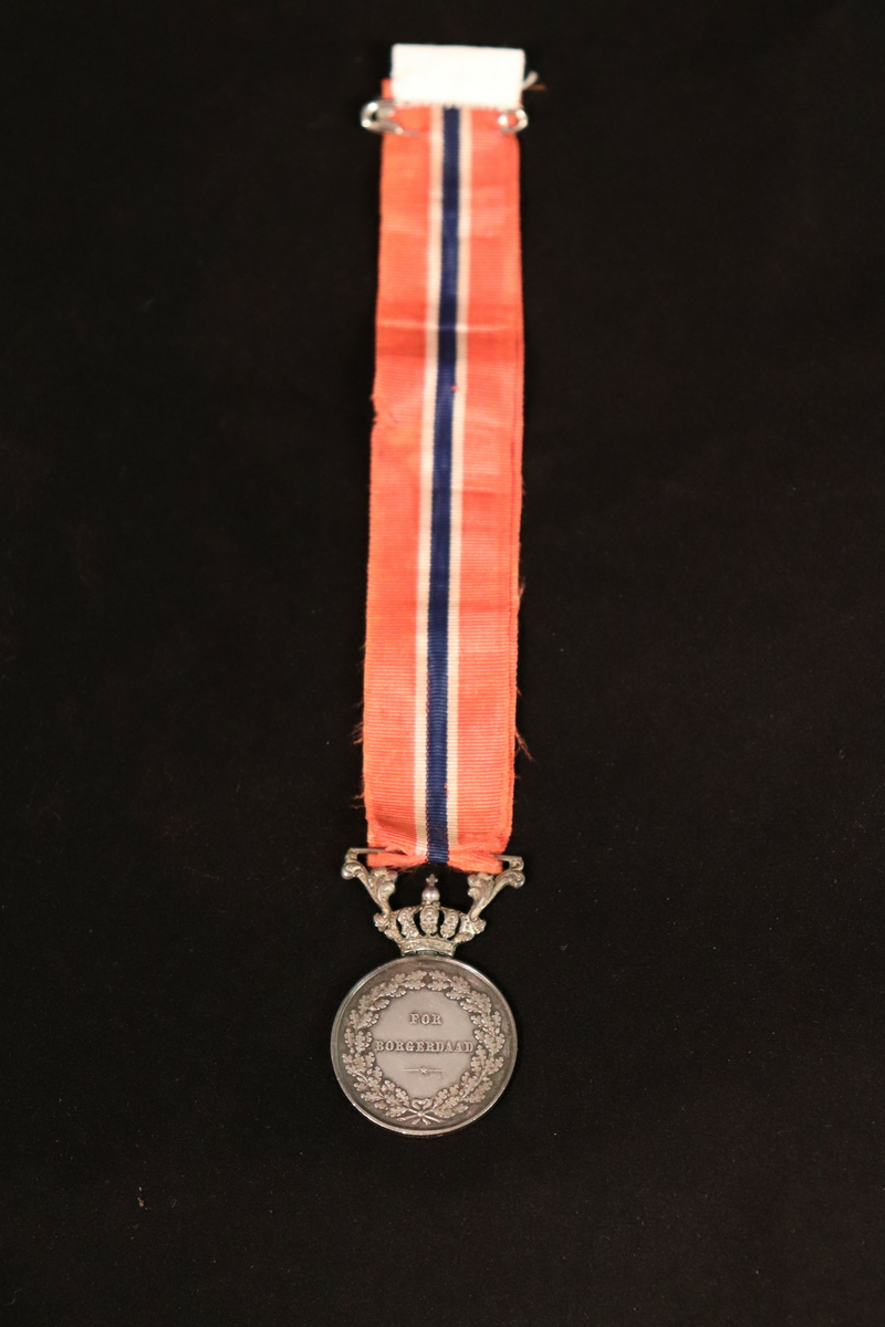 Med krone og sløyfe.
Side 1. er det skrevet Carl XIV Johan Norges Sver.g. og V. Konge.
Side 2. For Borgerdaad. (omkranset av laurbær).