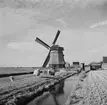 Väderkvarn söder om Zuiderzee, (nuvarande IJsselmeer). Tyskland-Holland-Belgien 1938. IJsselmeer är en insjö i Nederländerna som uppstod genom uppförandet av en dammbyggnad i Zuiderzee, en vik av Nordsjön.