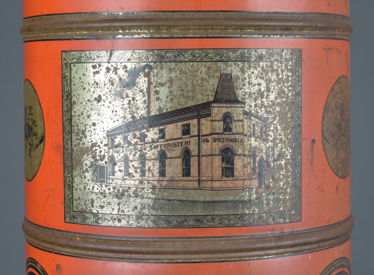 Kaffedispenser, sylinderformet, rødlakkert med reklame for Kvenild og Finne, Trondheim
Har lokk på toppen for å fylle i kaffebønner og ei luke/tut i bunnen for å hente ut kaffebønner som skal males. 

Slitt, noe rust