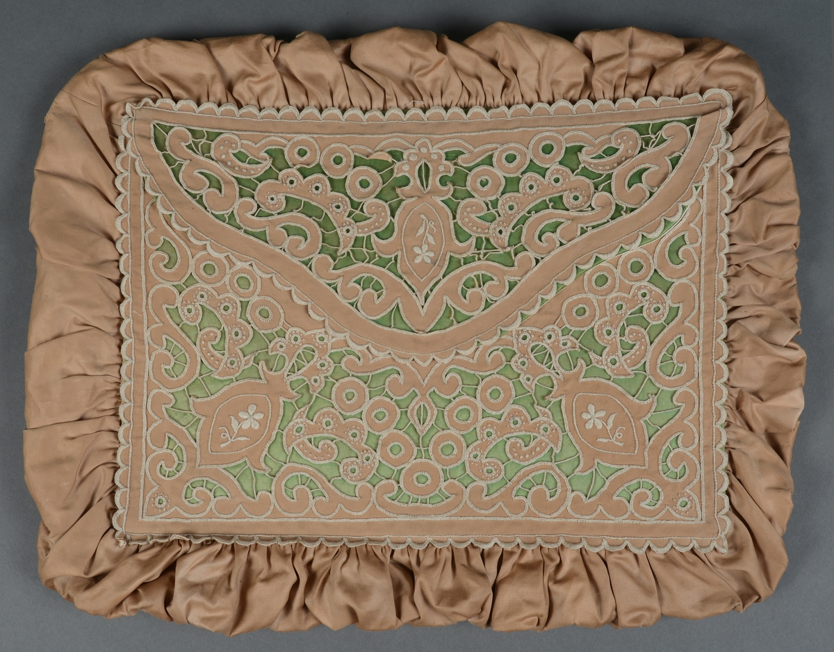 Rektangulær mappe med gjennomhullet broderi, "Venetiansk søm". Bunnen og lokkdelen er avstivet med en papp-plate, foret med hvitt chintzstoff. Sidene er av sammenrynket stoff som er sydd til bunnen og lokkdelene for hånd. Sidene er foret med samme stoff som bunn og lokkdelene. Under de broderte delene er det trekt med grønt silkestoff. Mappen inneholder 5 1/2 par mamelukker. 
Mamelukk 07, 1 singel, har brodert tungekant og engelskbroderi, håndsydd søm på utsiden og indresøm på innsiden av mamelukken, 2 knyttebånd.
Mamelukker 08, 1 par, har brodert tungekant og engelskbroderi, håndsydd, indresøm på ut- og innsiden av mamelukken, opprinnelig 2 knyttebånd på hver.
Mamelukker 09, 1 par, har innfelt mellomverk av kniplinger, 1 knyttebånd på utsiden i øvre kant, sømmene er håndsydde, indresøm på innsiden.
Mamelukker 10, 1 par, påsydd engelskbrodert kant, søm på innsiden av mamelukken, håndsydd, 2 knyttebånd på hver.
Mamelukker 11, 1 par, har brodert tungekant og engelskbroderi, håndsydd, indresøm på innsiden, opprinnelig 2 knyttebånd på hver.
Mamelukker 12, 1 par, påsydd engelskbrodert kant, søm på innsiden av mamelukken, håndsydd, 2 knyttebånd på hver.