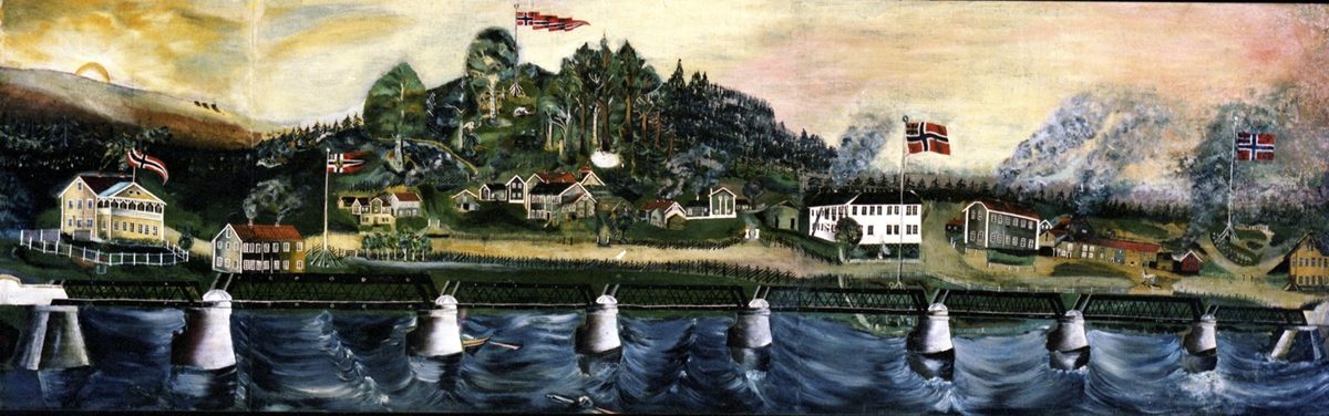17. mai i Leiret i Elverum med Glomma i forgrunnen, ved den gamle brua, en jernkonstruksjon.