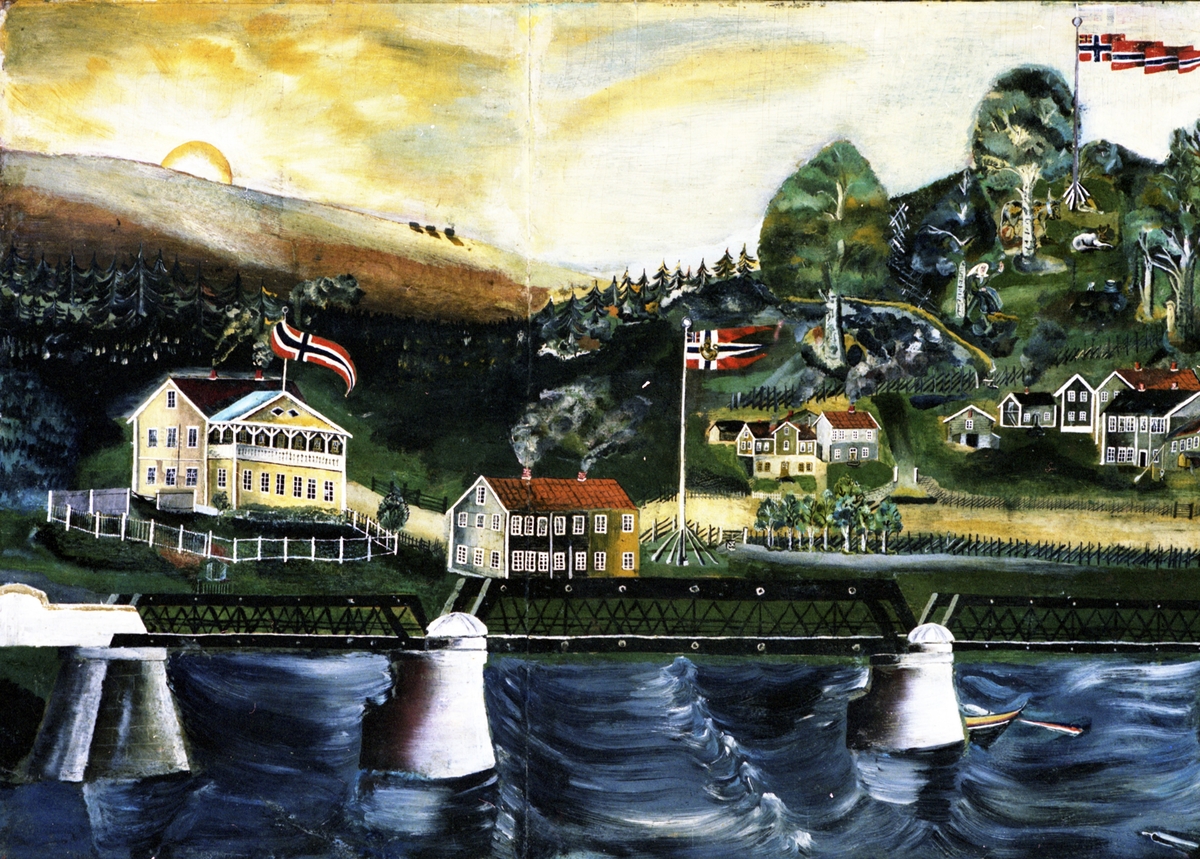 17. mai i Leiret i Elverum med Glomma i forgrunnen, ved den gamle brua, en jernkonstruksjon.