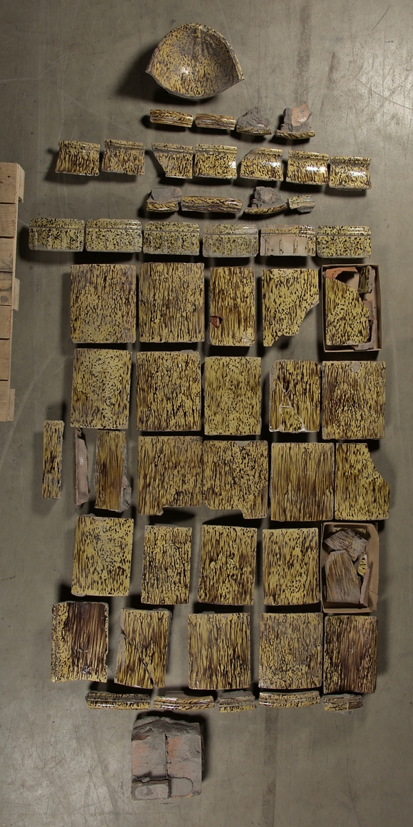 Kakel, gult och brunspräckligt.