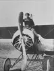 En man sitter på nosen på flygplan Thulin D, omkring 1914-1918.