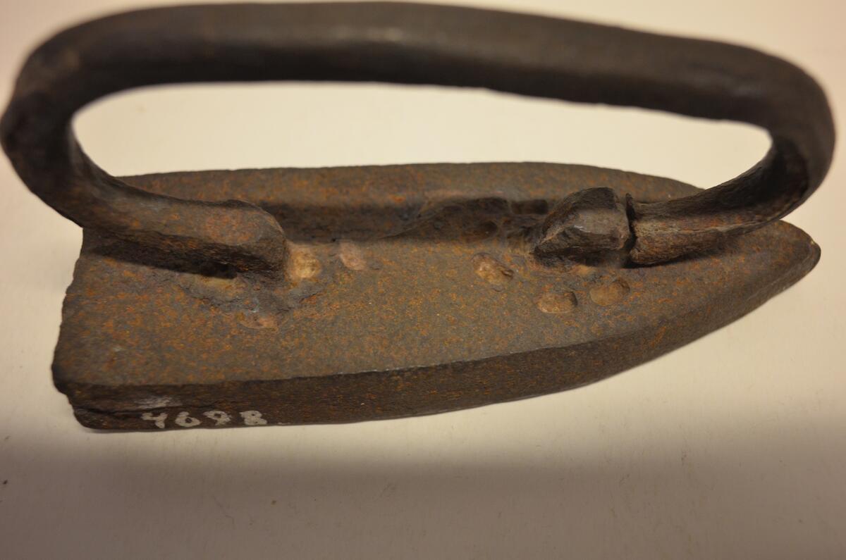 Strykjärn av järn. Bygelformigt handtag. Enligt uppgift från senare hälften av 1700-talet. Ö. Tåsjö, Tåsjö, Ångermanland