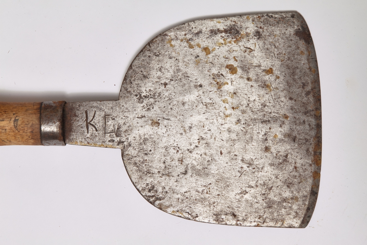 Halvrundt blad med slipt egg. Stålblad og dreid håndtak av bjørk med knott på toppen. Solid skjeftet. Brukt på gårdsbruk ved slakting.