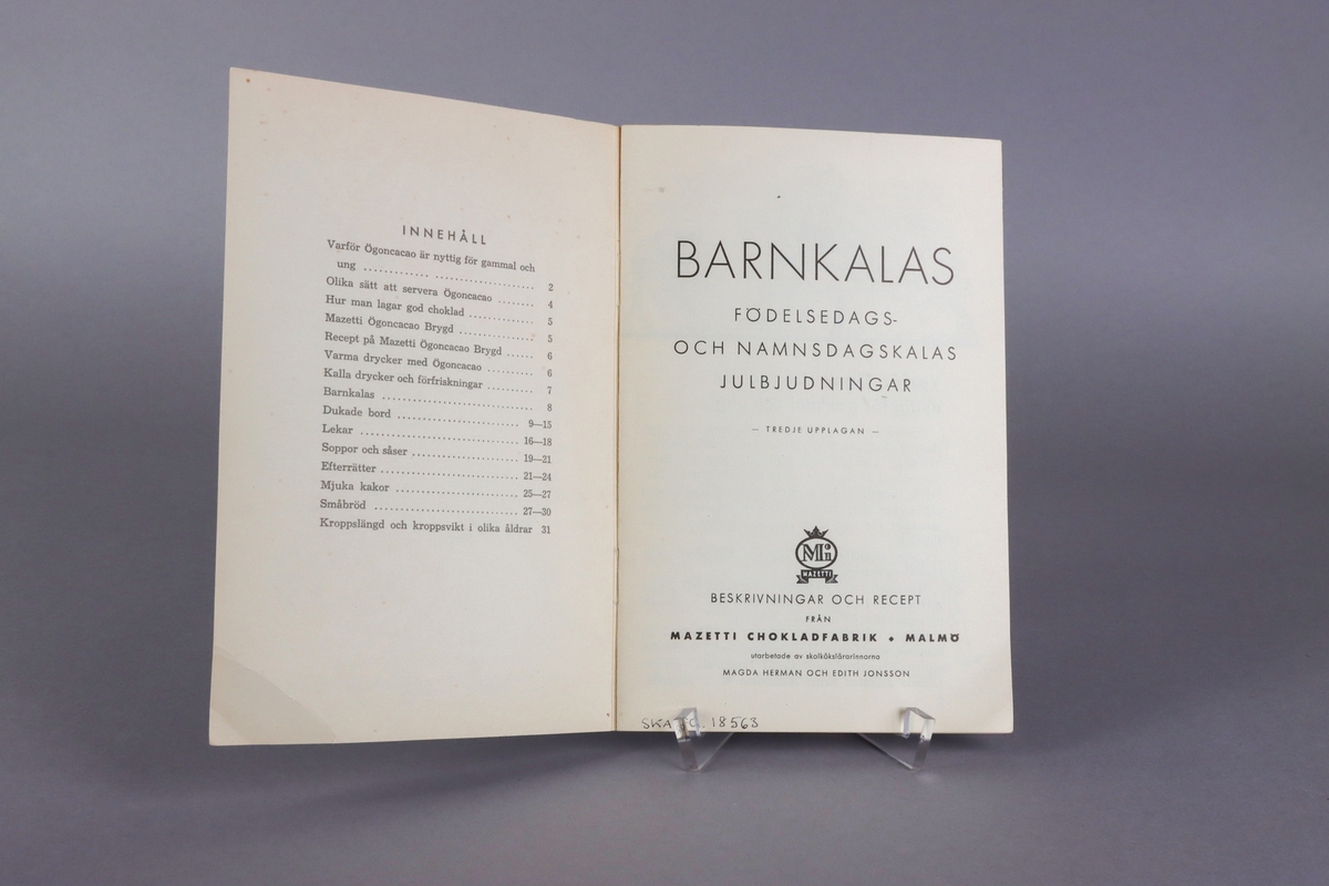 Black and white illustrated promotional booklet titled “ Barnkalas “ issued by Mazetti Chokladfabrik Malmö late 1930´s, 31 pages. Front and back cover with color illustrations. 
The front showing a table set for a birthday party, with two children and the back an advertisement for cocao powder. Inside the booklet a complete list and description, on how to organize a children´s party, how to set the table and what to serve.