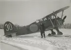 Porträttfoto av flygförare Kurt Edenholm vid flygplan J 11, vintertid, cirka 1941-1944.

Bildtext vid foto: 