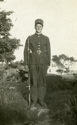 Helportrett av Tore Lima i uniform og med gevær.