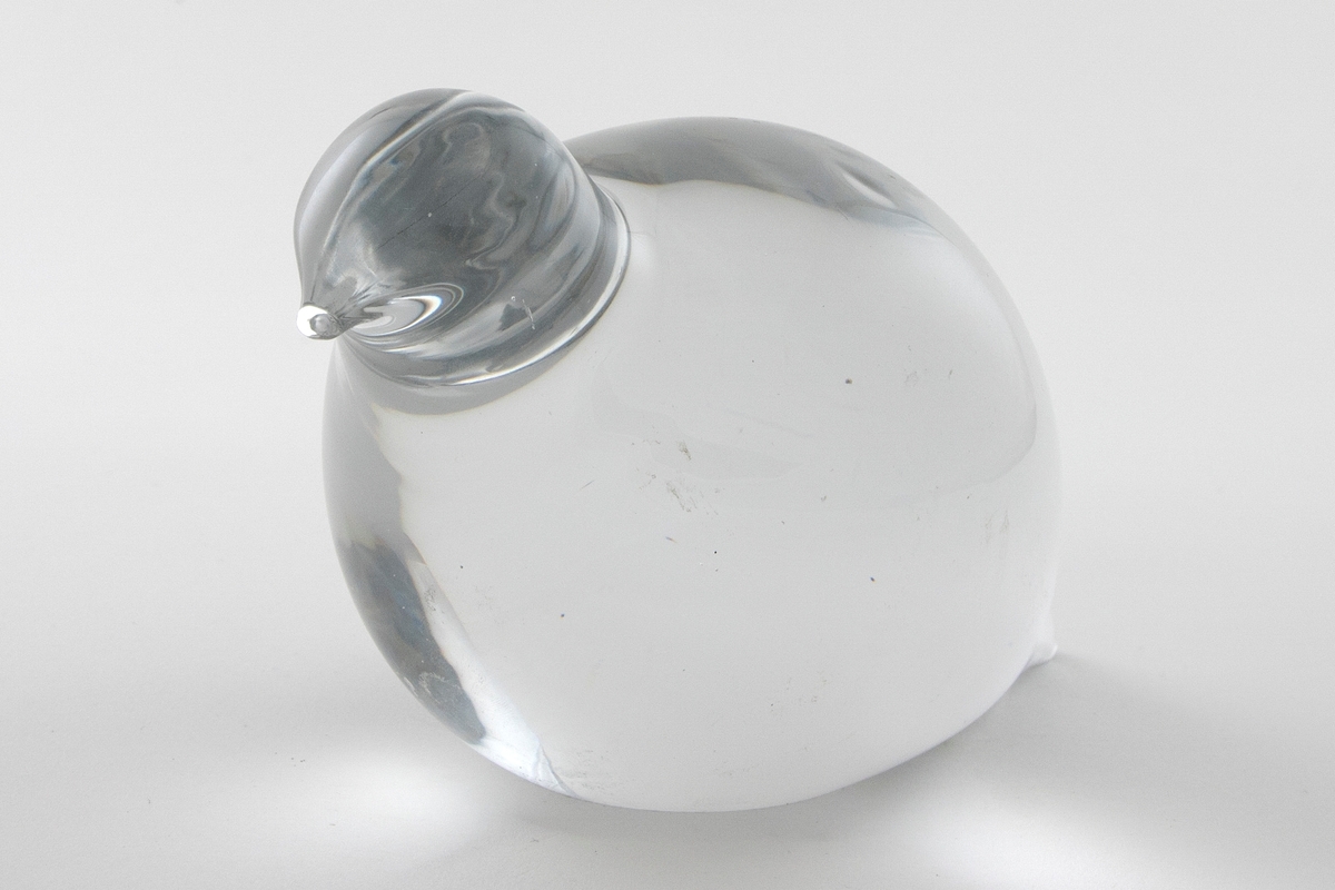 Glassfigur i massivt klart glass uten dekor. Figuren har en stilisert fugleform, og skal forestille en rype.