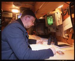 Tore Gabrielsen studerer kart i bestikklugaren på "Anna Rogd