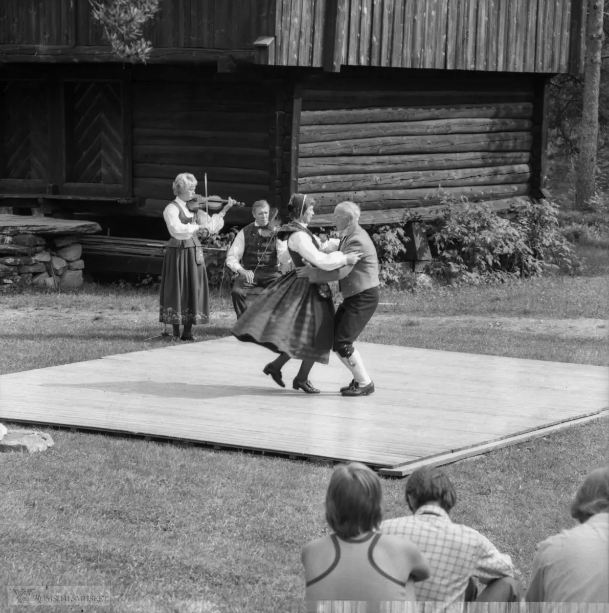 Innspilling av filmen "Romsdalsspringaren" på Eidetunet på Romsdalsmuseet i 1974. Filmen var laget av Egil Bakka. Danserne var fra Bondeungdomslaget i Molde. Spelemennene og spelekvinnen var også fra Bondeungdomslaget og Romsdal Spelemannslag.