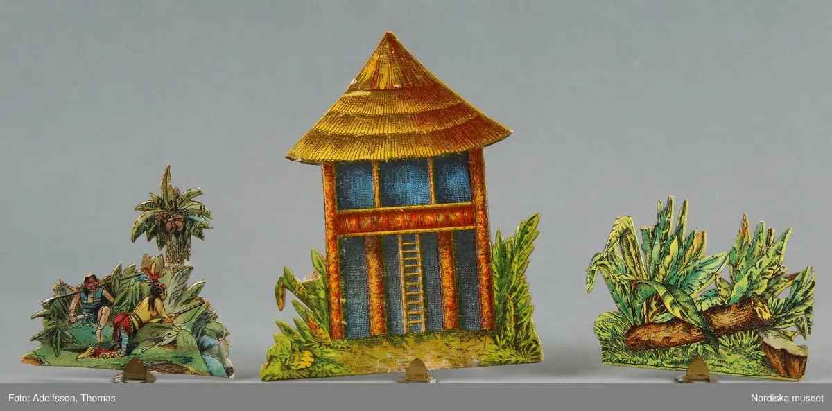 Pappersleksak i flera delar (18 lösa bitar enligt katalogkort) föreställande kamp mellan indianer och cowboys i vilda västern.