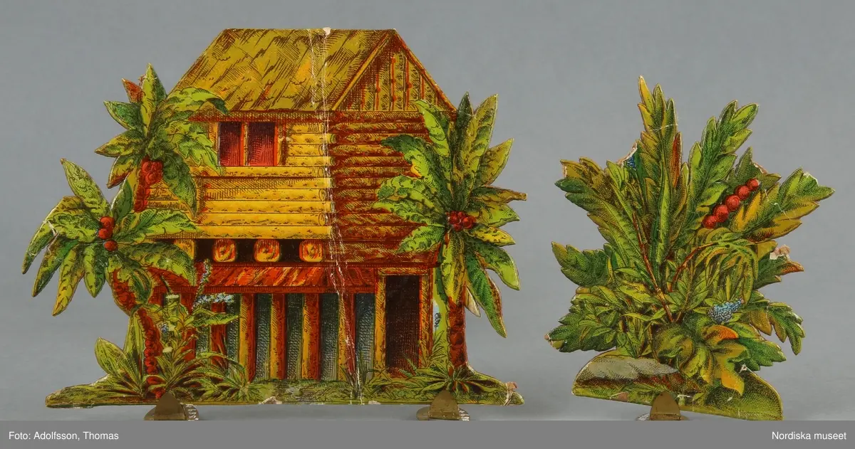 Pappersleksak i flera delar (18 lösa bitar enligt katalogkort) föreställande kamp mellan indianer och cowboys i vilda västern.