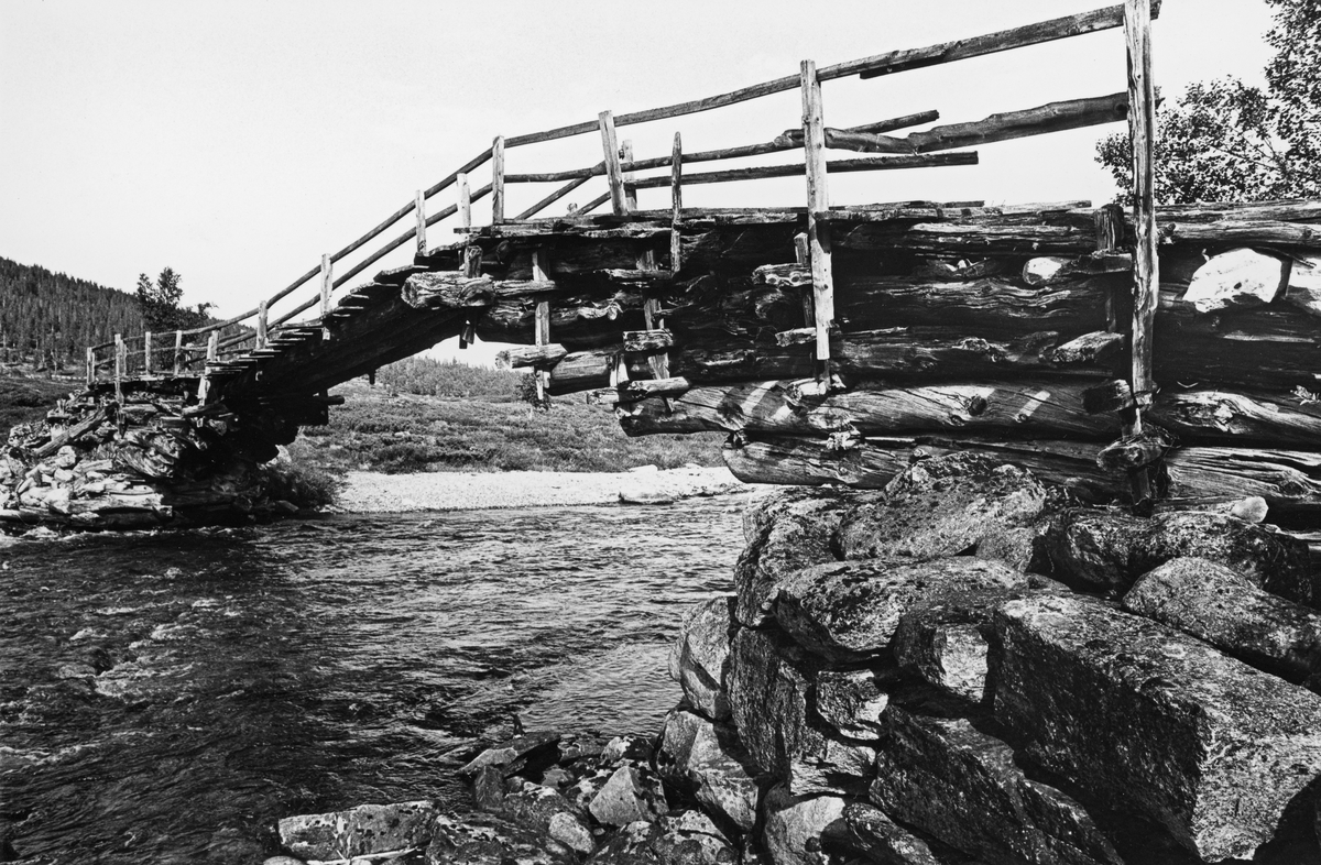 Godt bevart utliggerbru, Angardsbrua i Grimsdalen på Dovre. To bilder; farge- og svartkvittopptak fra omtrent samme sted.  Viser brua med tømmerkonstruksjoner på steinkar.  Fotografiet er publisert i tidsskriftet Statsskog nr. 1 1979.