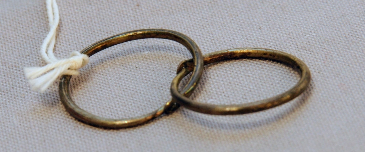 En oval ask av svept spån. Grönmålad, locket har röd kant, i mitten är en enkel ros målad. Äskan innehåller en fingerring, två mindre spännen, öronringar och ett litet hängsmycke i form av ett hjärta.