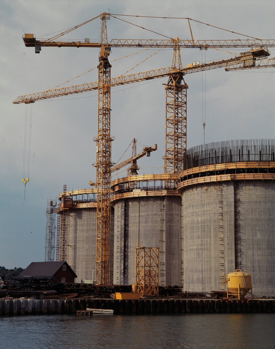 Foto av byggingen av understellet til en Condeep-plattform. Navnet kommer av engelsk «concrete deep water structure», eller dypvannskonstruksjon av betong.  Fotografens bildetekst: Betong understell til oljerigg bygges Norwegian Contractors a.s., Troll op. Norske Shell  Group no. 64-35-10-00   Picture no. 340458