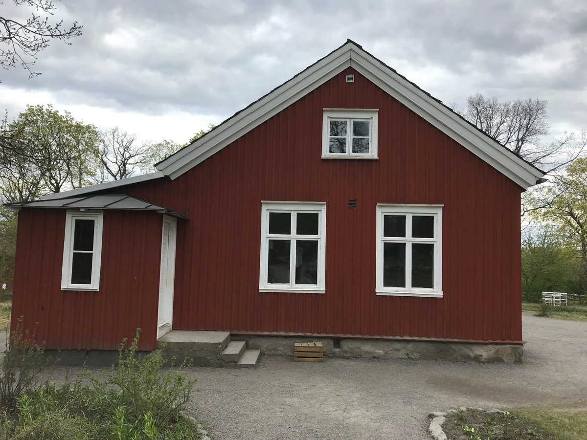 Väla skola är en timrad byggnad i en våning, klädd med stående locklistpanel. Fasaden är målad med röd slamfärg, snickerierna är målade med vit linoljefärg. Taket är ett sadeltak klätt med skiffer från Dalsland. Skorstenen är centralt placerad över nock. Skolsalen är inrymd i den vänstra delen av byggnaden, lärarbostaden i den högra. 

Byggnaden uppfördes efter ritningar av ryttmästare Carl Fredrik Toutin under åren 1846 och 1847 i Väla socken, Kållands härad några mil sydväst om Lidköping i Västergötland. Huset genomgick ett flertal reparationer under 1800-talets senare del. 1910 gjordes en omfattande upprustning samt tillbyggnad. På Skansen visas hur huset såg ut efter det.

Väla skola flyttades till Skansen 1966.  