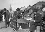 Torghandel på Stortorget, torgstånd med handlare och kunder.