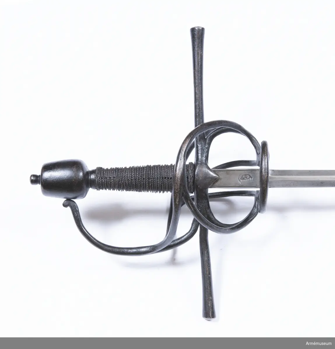 Den smala, tveeggade klingan har flata åsar. Längst upp har den en cirka 5 cm lång ansats, som har rektangulärt tvärsnitt. Ansatsen har på var sida längs långkanterna en ingraverad rand, och på var sida är en halvmåne inslagen. Stämpeln är en tysk efterbildning av Toledosmeden Juan de Lunas stämpel.

Fästet är av svärtat järn. Knappen har cirkelrunt tvärsnitt och  avsmalnar något uppåt. Översidan är svagt och undersidan är starkt avrundad. Nitknappen är närmast cylindrisk och skiljs nedtill genom en instrypning från den lilla avrundade foten. Halsen är kort, har cirkelrunt tvärsnitt och skiljs genom en instrypning från knappen. Träkaveln avsmalnar något uppåt. Dess eggsidor är flata, men flatsidorna är svagt kullriga. Upp- och nedtill finns en smal krans av snodd järntråd. Kavellindningen består av en ganska smal höger- och en liknande vänstersnodd järntråd, men ursprungligen har det tydligen funnits flera trådar.
Parerstången är rak och har cirkelrunt tvärsnitt. Den vidgas rätt mycket mot de svagt avrundade ändarna. Från korsets undersida går på var flatsida en kort trekantig flik nedåt. Från korset vid var och en av klingans eggsidor går en stor fingerhake nedåt. Fingerhakarnas nedre ändar förenas på yttersidan genom en horisontal "åsnehovsbygel" och från samma ändar utgår också en stor, snedställd parerbygel, vars översida står något över parerstången. Från mitten på sistnämda bygel går en spång till handbygeln, med vilka den förenas något nedanför bygelns mitt. På innersidan går en nedtill trekluven gaffelspång från fingerhakarnas nedre ändar till handbygeln, vilken den träffar något nedanför bygelns mitt. Alla byglar och spänger har cirkelrunt tvärsnitt.