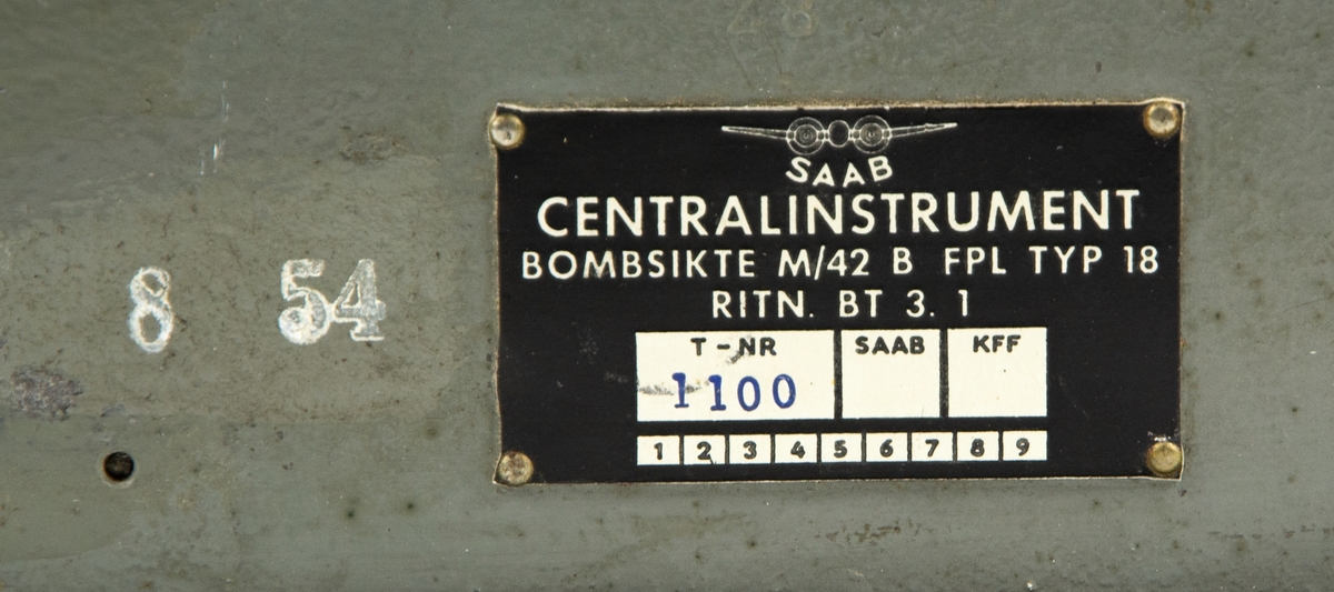 Centralinstrument för bombsikte m/42, avsett för fpl B18. På locket står att materielet är ömtåligt och skall behandlas som ägg, Aktas noga för stötar och slag, Plomberingen får ej brytas annat än med KFFS tillstånd.