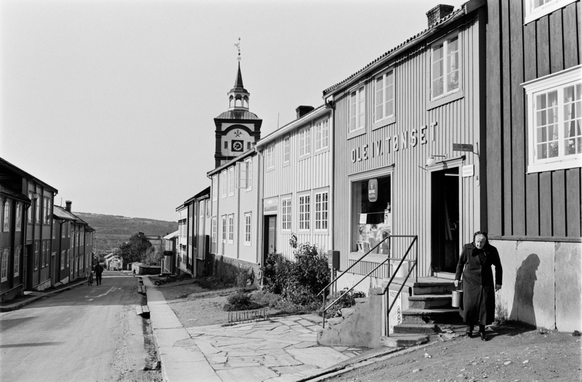 En kvinne går ut av en butikk på Røros.