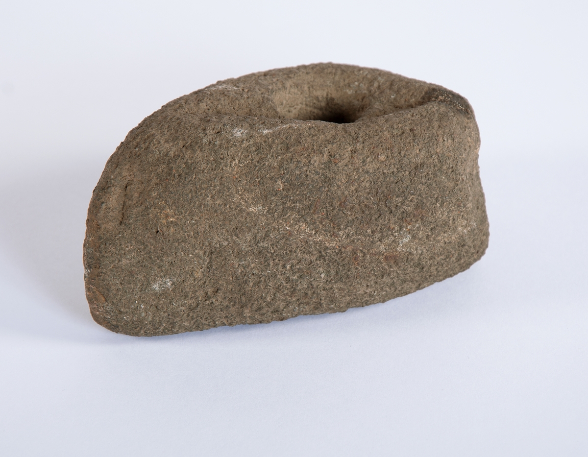 Bred og kort skafthulløks med trapesformet tverrsnitt og rett, uregelmessig nakke. Helt prikkhogd.