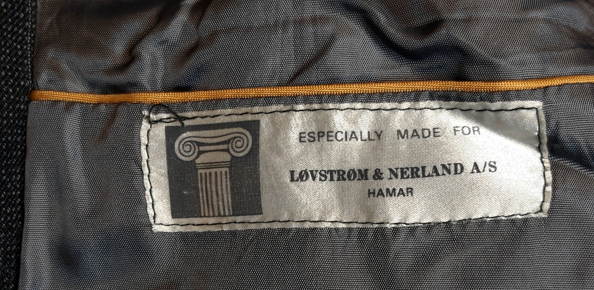Stripete enkelspent jakke med slag med ett knapphull og krage. 2 knapper foran. 2 passepoilerte lommer foran. Splitt bak. 2 knapper nederst på ermene. Brystlomme på venstre side. 3 innerlommer. Avrundet i nedre kant foran på begge sider.