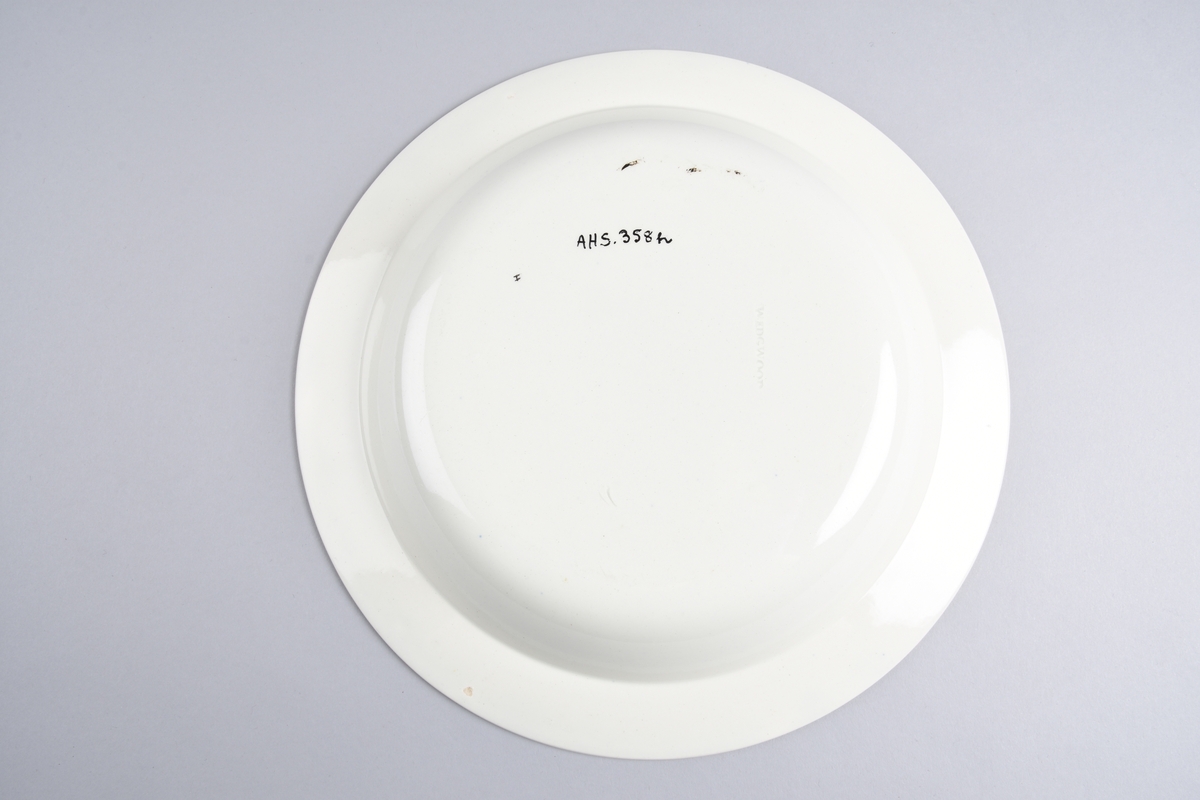 Stilisert borddekor i to grønnfarger langs kanten.