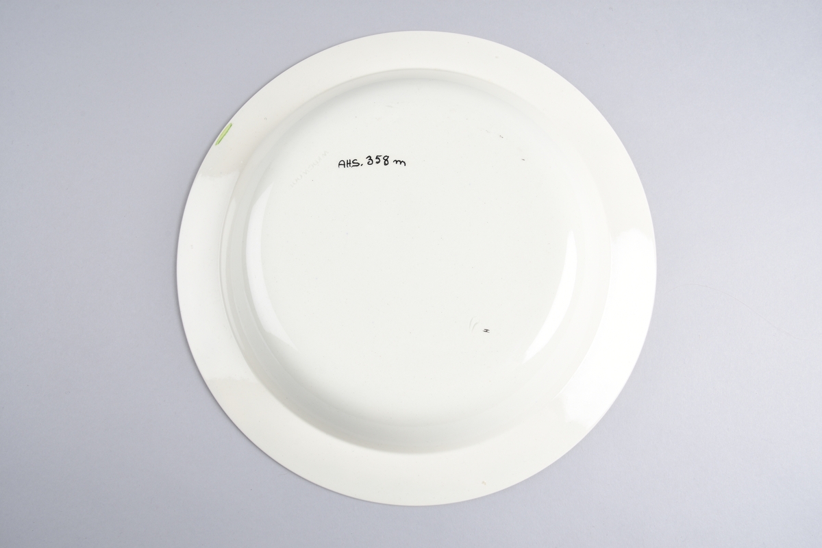 Stilisert borddekor i to grønnfarger langs kanten.