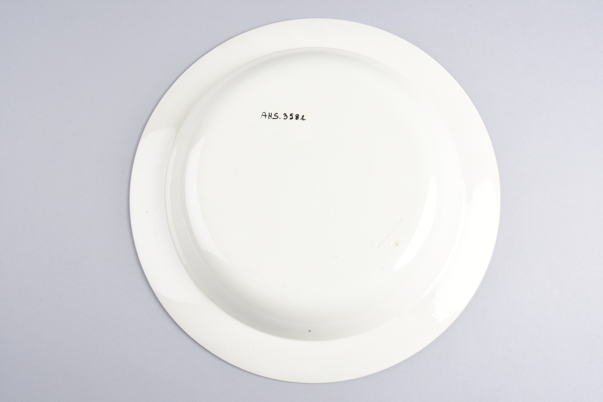 Stilisert borddekor i to grønnfarger langs kanten.