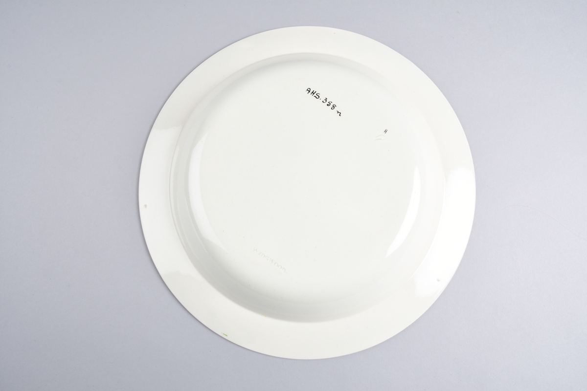 Stilisert borddekor i to grønnfarger langs kanten.