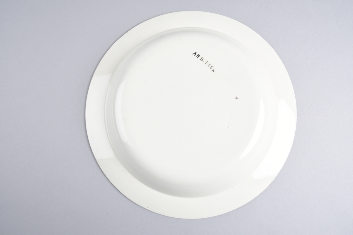 Stilisert borddekor i to grønnfarger langs kanten.