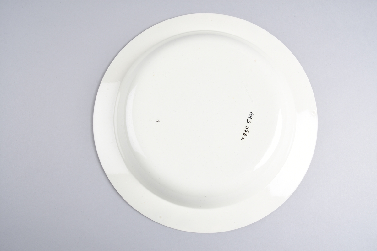 Stilisert borddekor i to grønnfarger langs kanten.