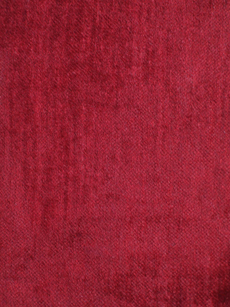 Rødt møbelstoff i plysj, ullhår på bomullsbunn.