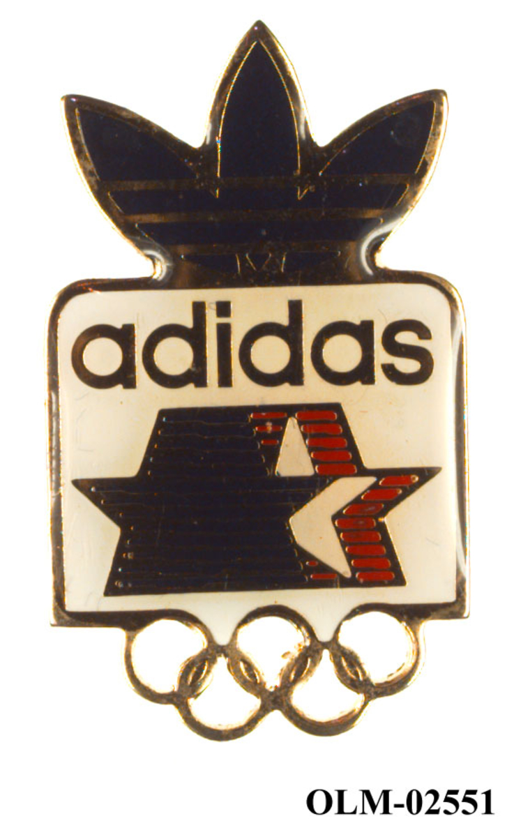 Merke med emblemet for de olympiske sommerleker i Los Angeles i 1984. Deler av merket er formet som adidas-logoen og de olympiske ringene.